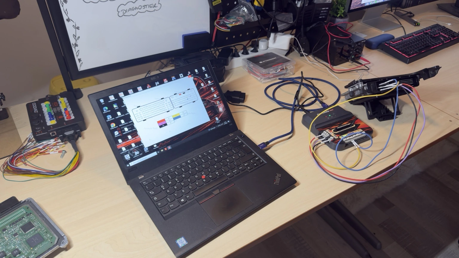 ECU-werkstation met laptop, interfaces en aangesloten bekabeling.